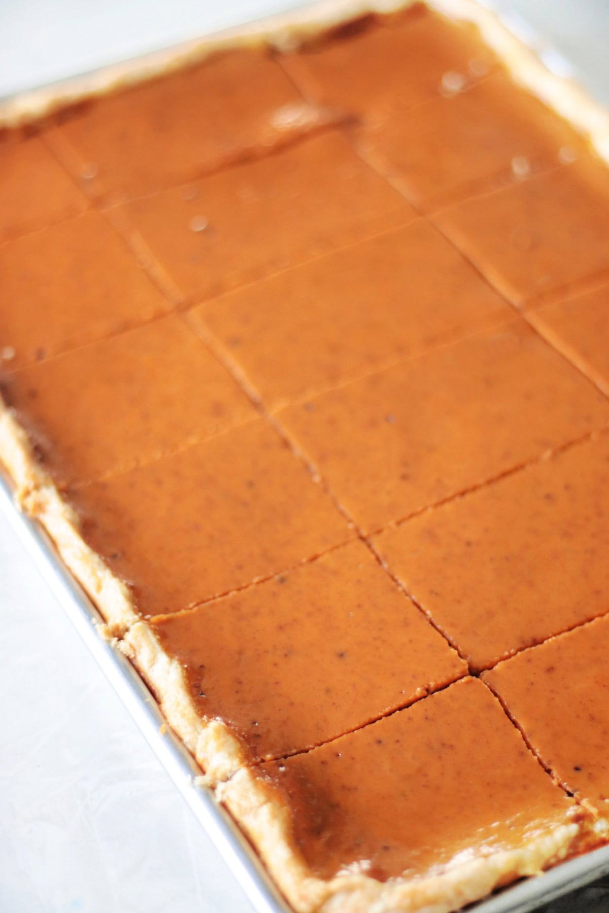 Baked pumpkin slab pie cut into slices.