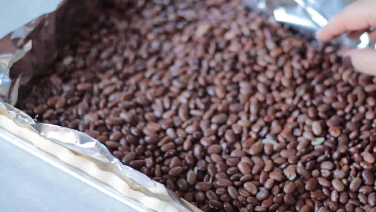 Foil on top of pie crust, covered with beans.