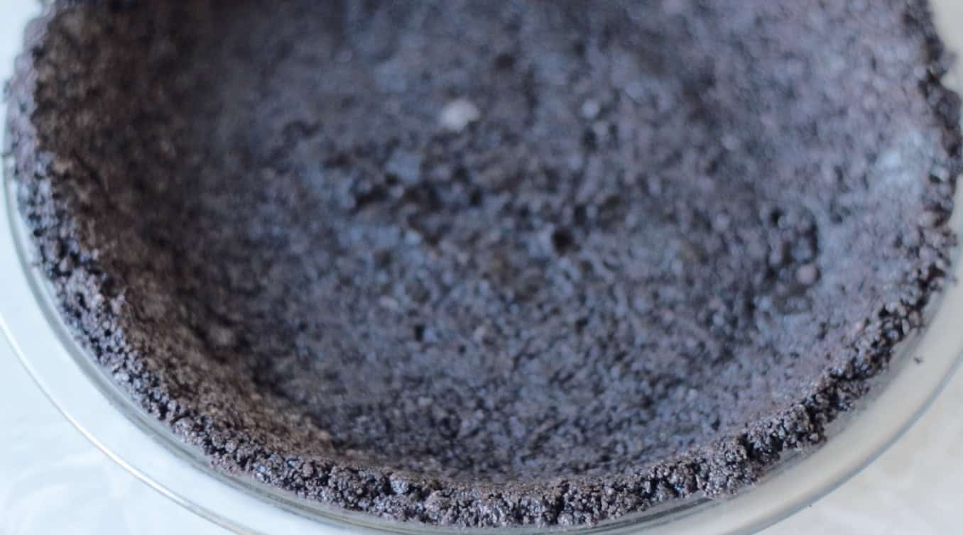 Oreo pie crust in glass pie pan.