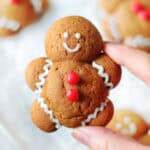 Hand holding gingerbread man cookie.