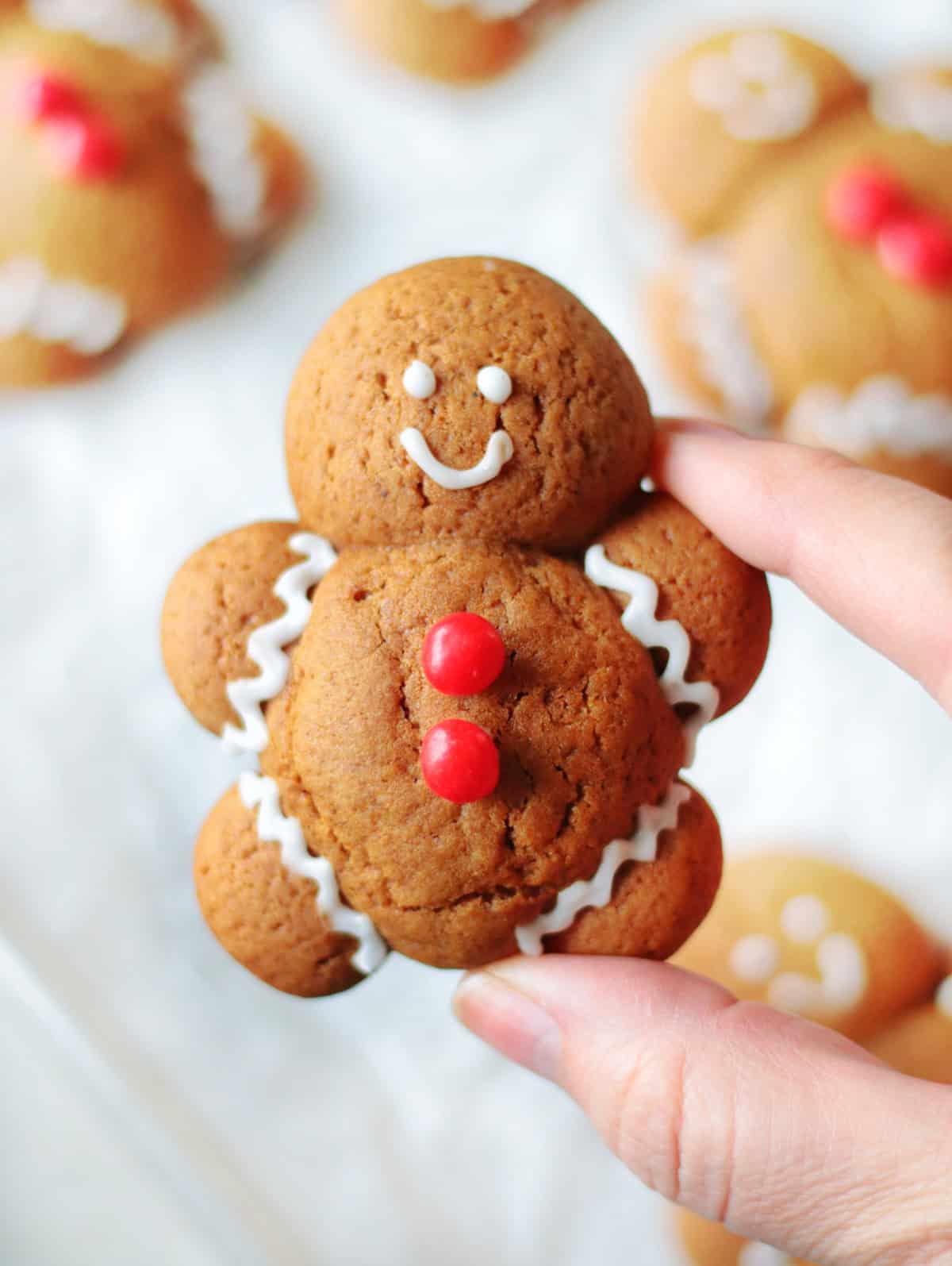 Hand holding gingerbread man cookie.