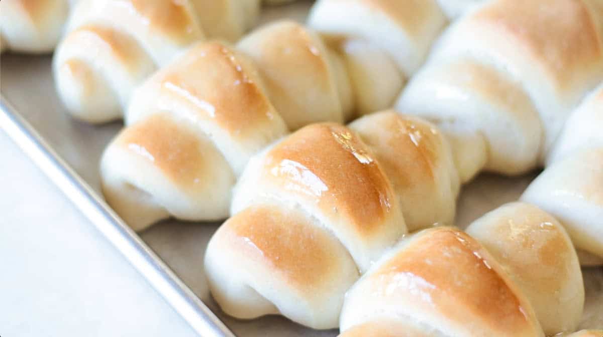 Baking sheet of baked crescent rolls.