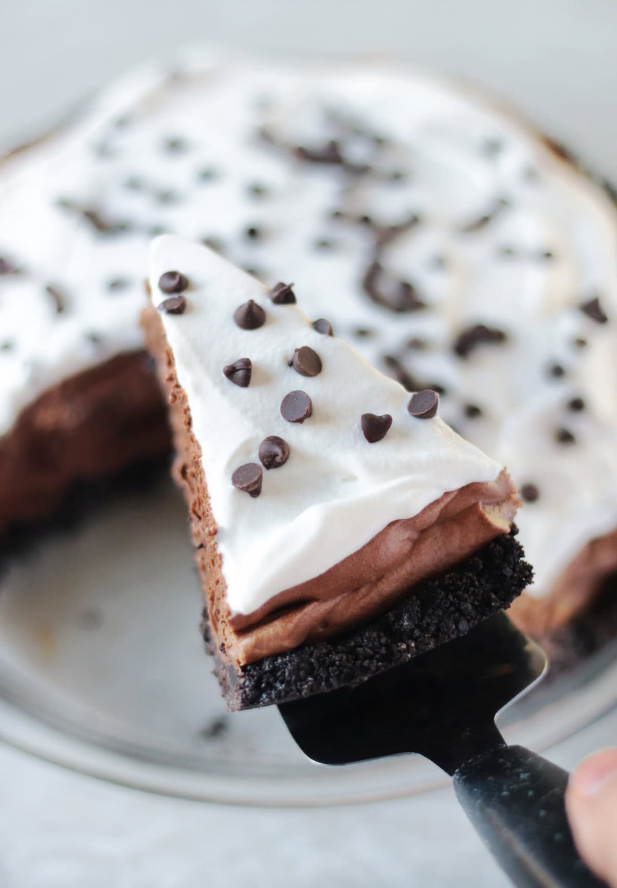 Slice of no bake French silk pie on pie serving tool.