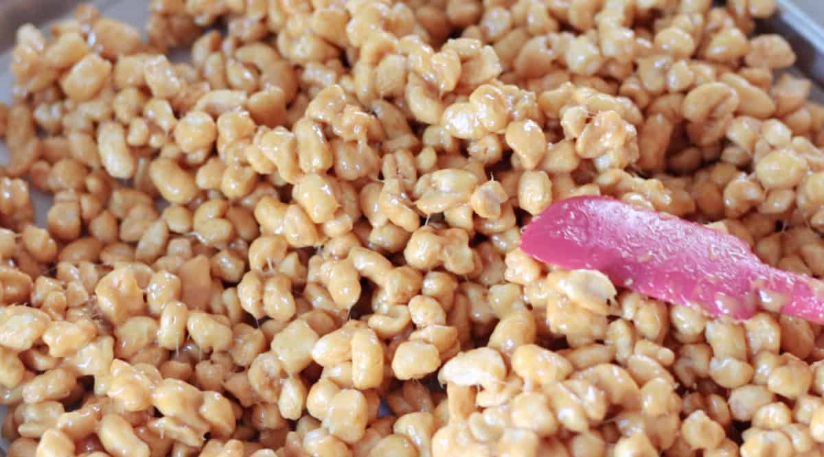Spatula pressing mixture into a baking sheet.