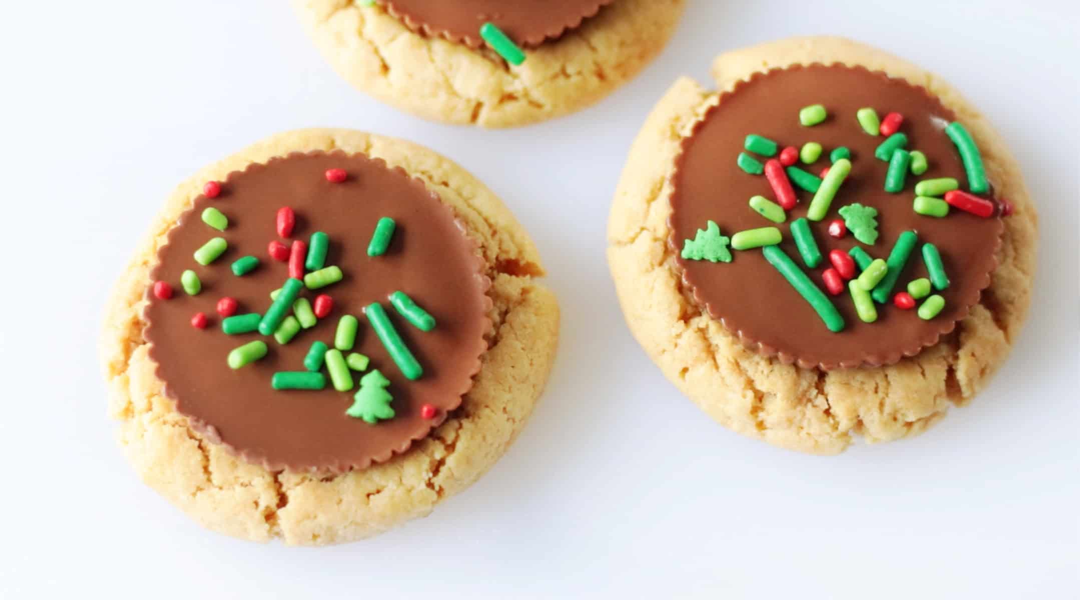 Peanut butter cup cookies with red and green sprinkles.
