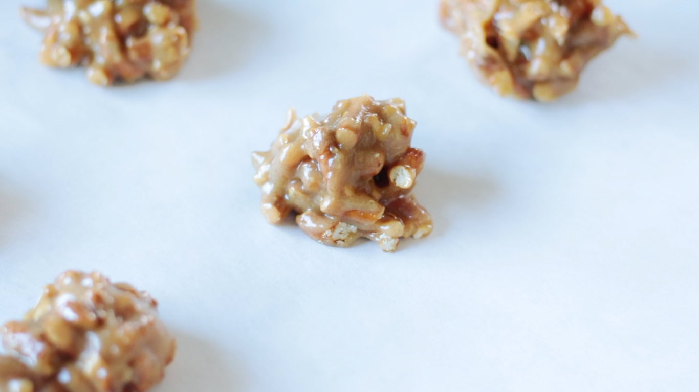 Peanut butter clusters on parchment paper.