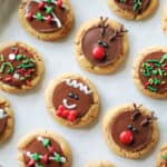 Holiday peanut butter cup cookies on parchment paper.