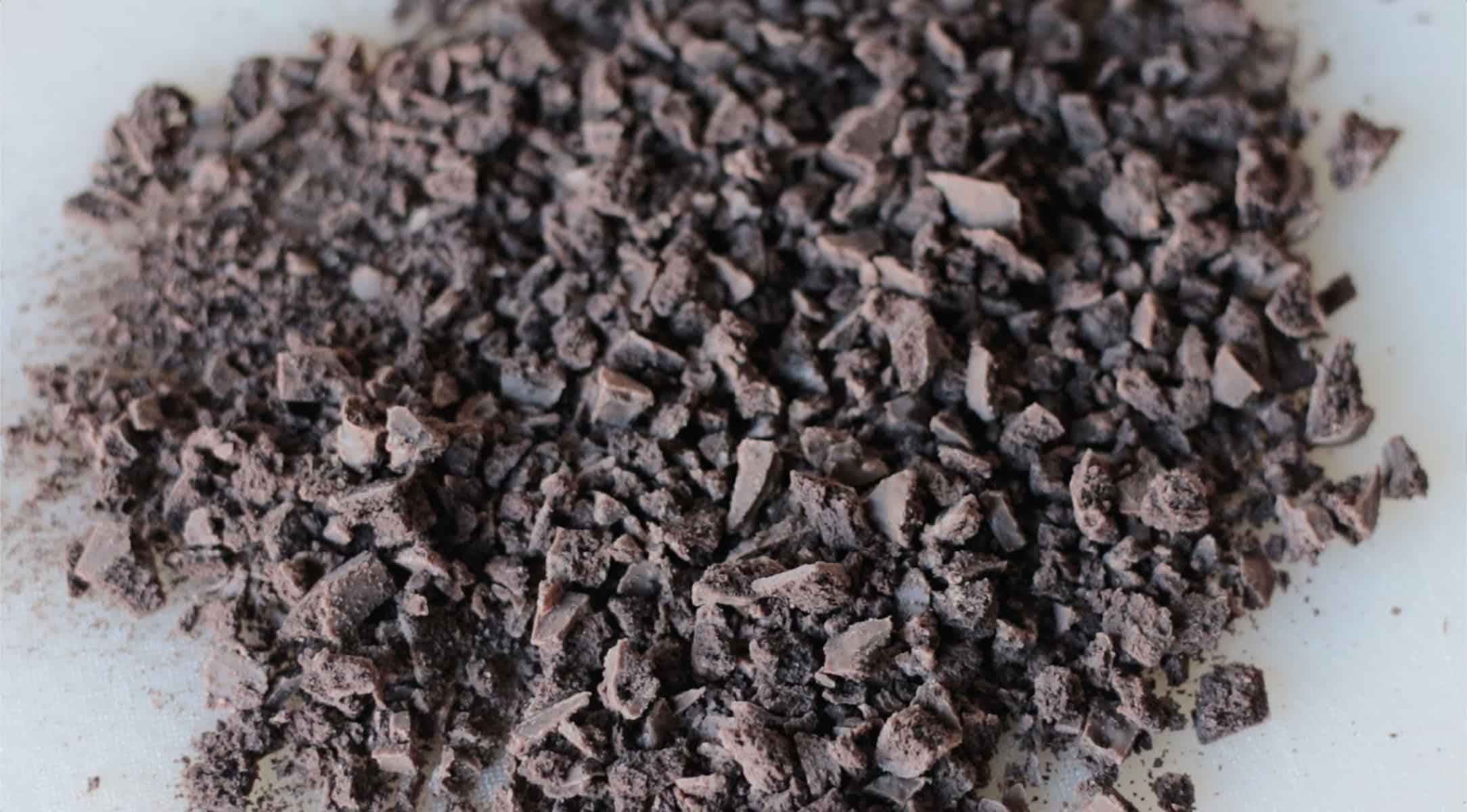 Chopped chocolate mint cookies on cutting board.