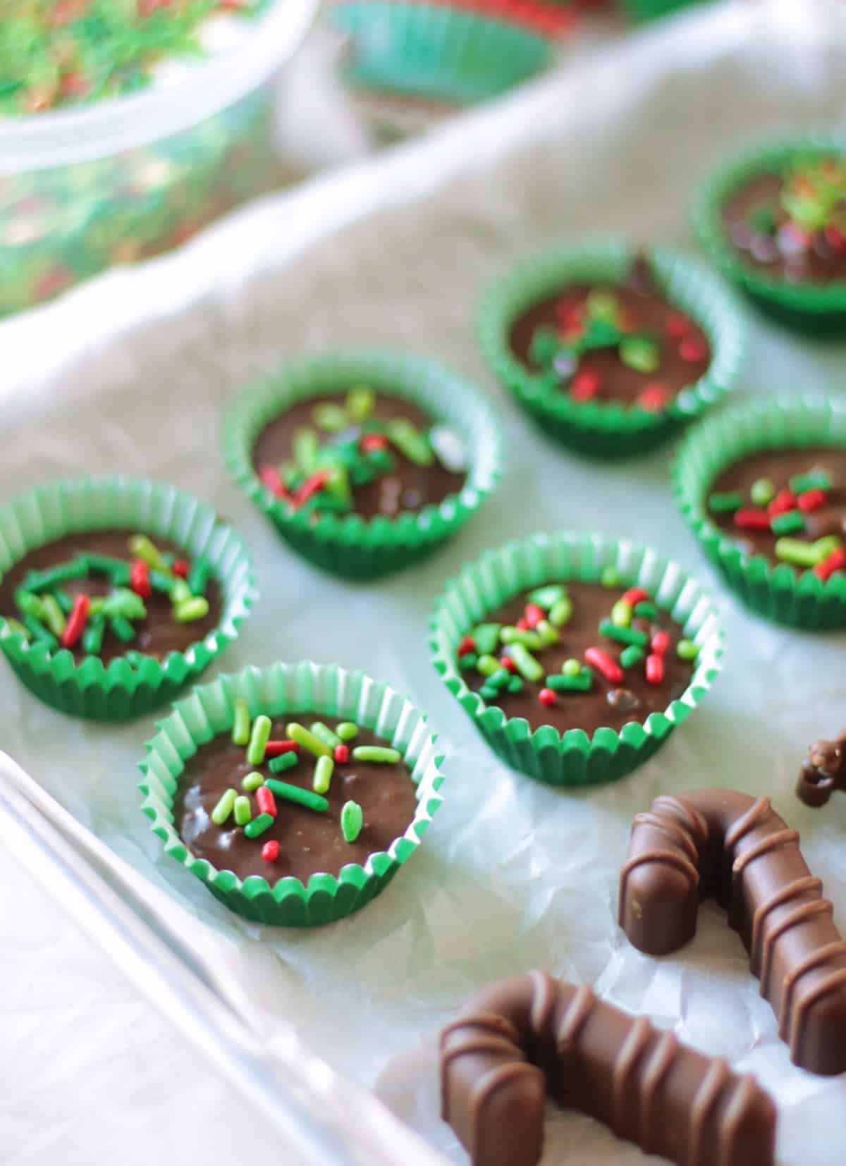 Baking sheet with rows of thin mint chocolates and molded chocolates.
