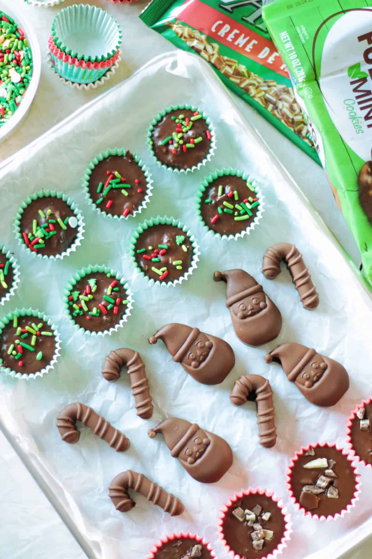 Baking sheet with rows of thin mint chocolates and molded chocolates.