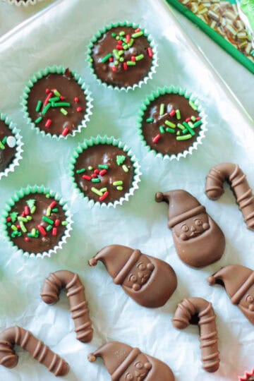 Baking sheet with rows of thin mint chocolates and molded chocolates.
