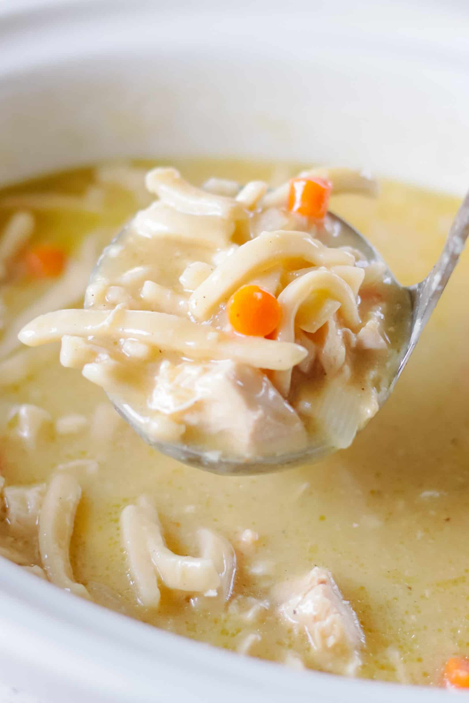 Ladle of chicken-no-noodles in a slow cooker.