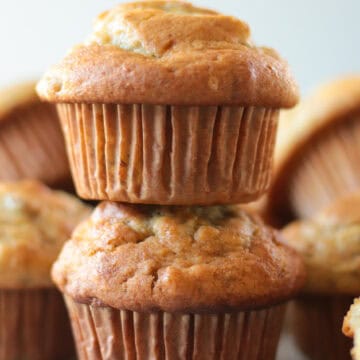 two banana nut muffins staked on top of eachother.