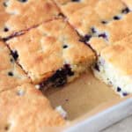 Pan of blueberry cake sliced into squares.