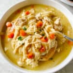 White bowl of chicken and noodles.