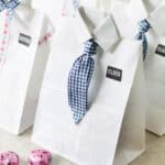 4 bags decorated like dress shirts with missionary tags.
