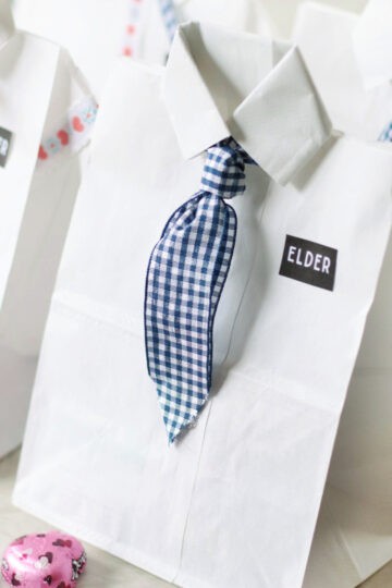 4 bags decorated like dress shirts with missionary tags.