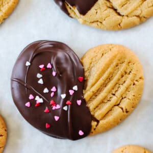 Peanut butter valentine's day cookie half dipped in chocolate.