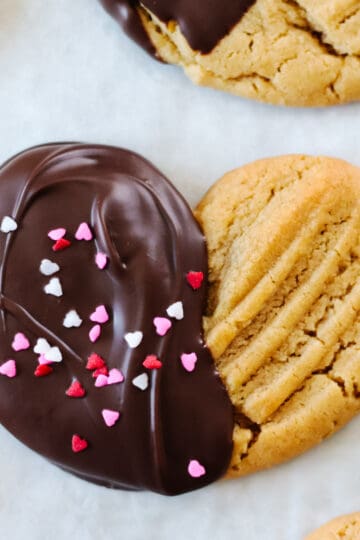 Peanut butter valentine's day cookie half dipped in chocolate.