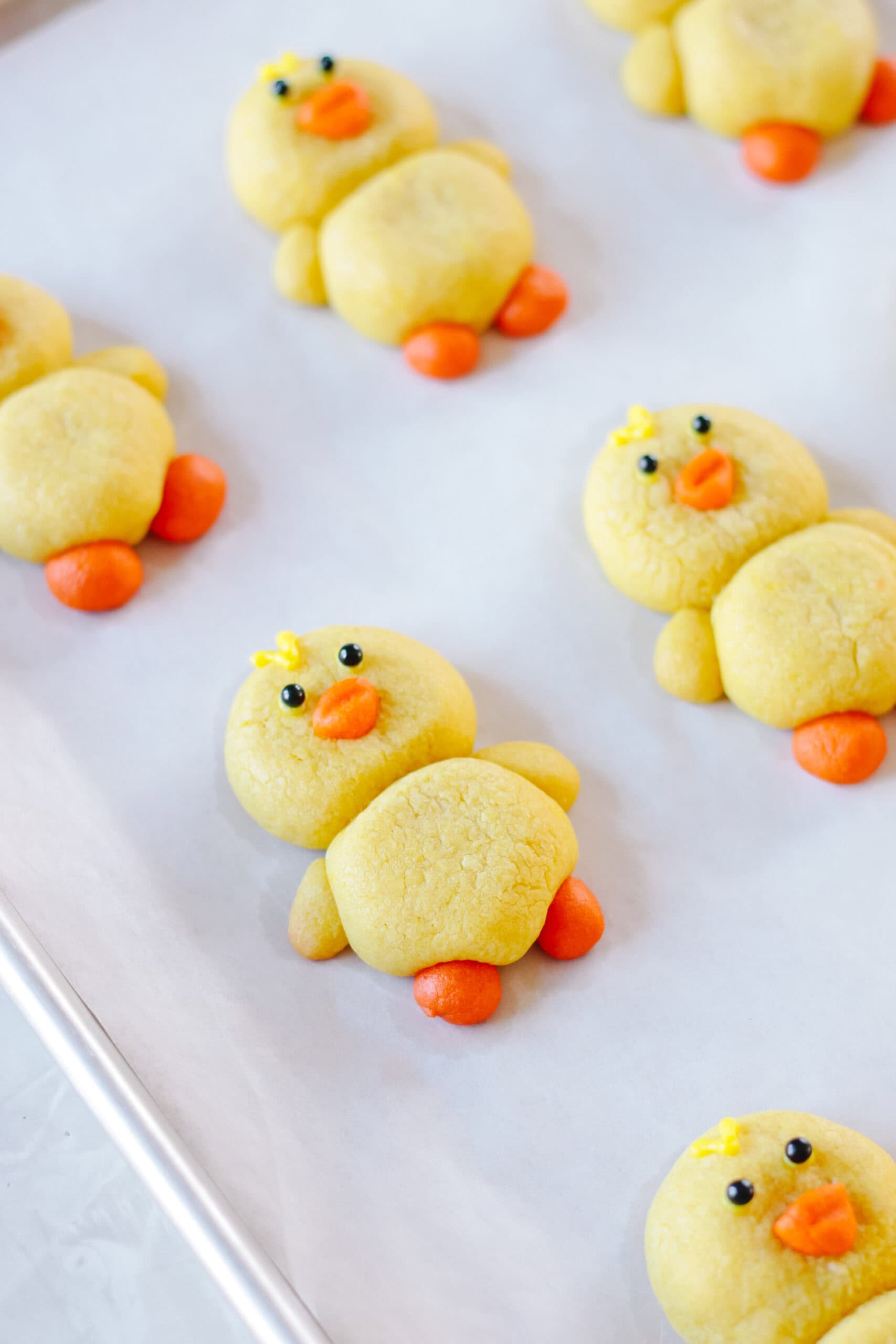 Yellow chick sugar cookies on baking sheet.