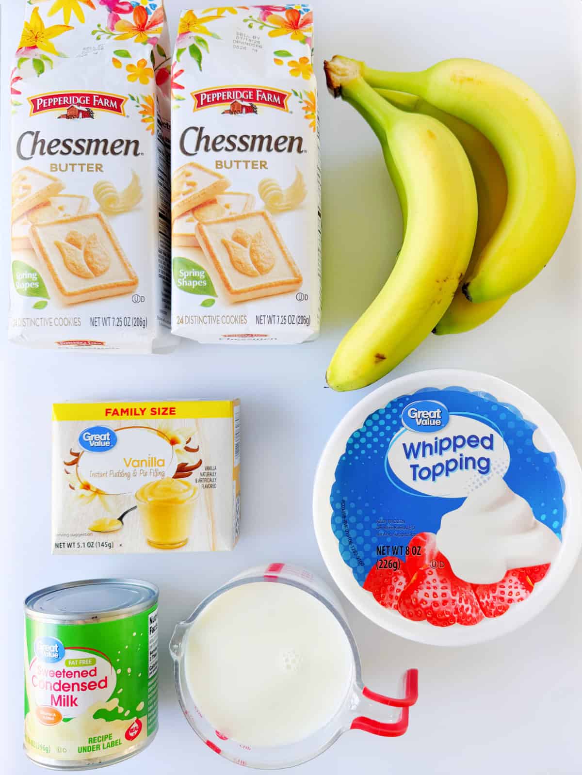 Bags of butter cookies, bananas, box of vanilla pudding mix, container of whipped topping, cup of milk, and can of sweetened condensed milk.
