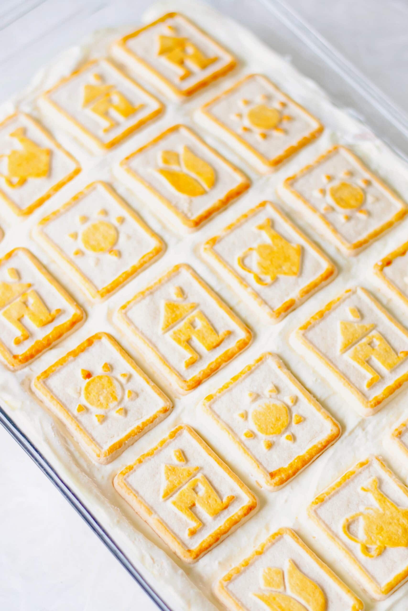 Banana pudding topped with Chessmen cookies in baking dish.