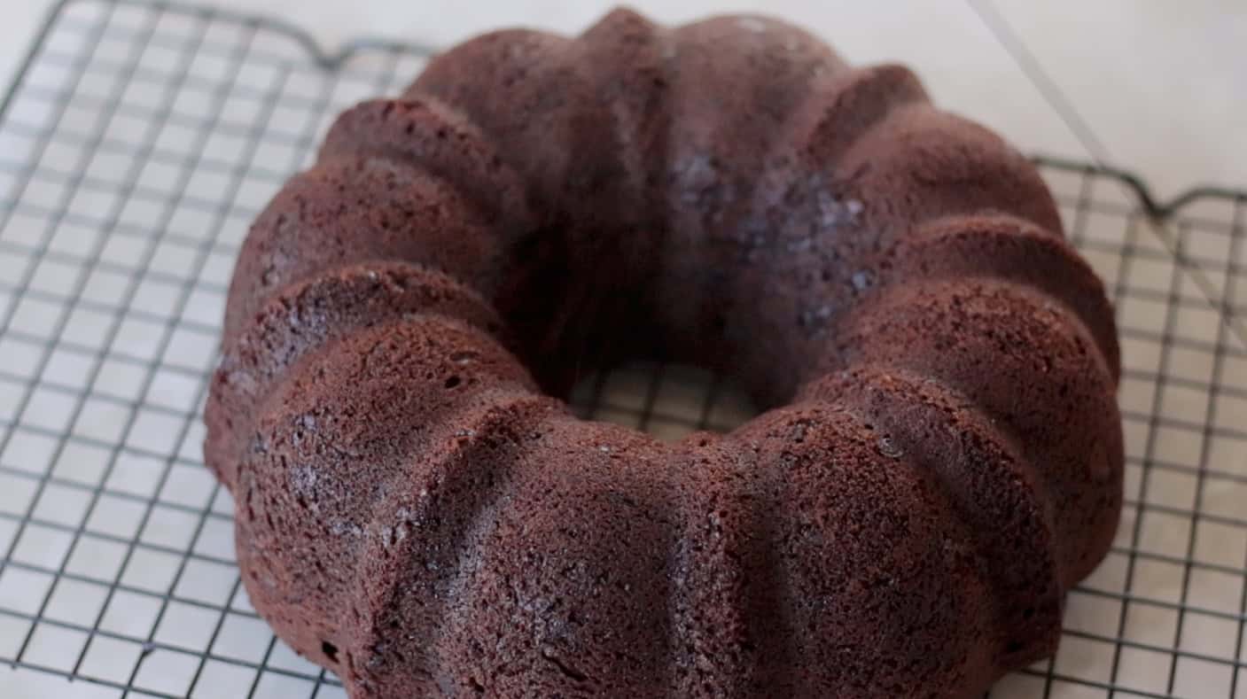 Chocolate bundt cake on cooling rack.