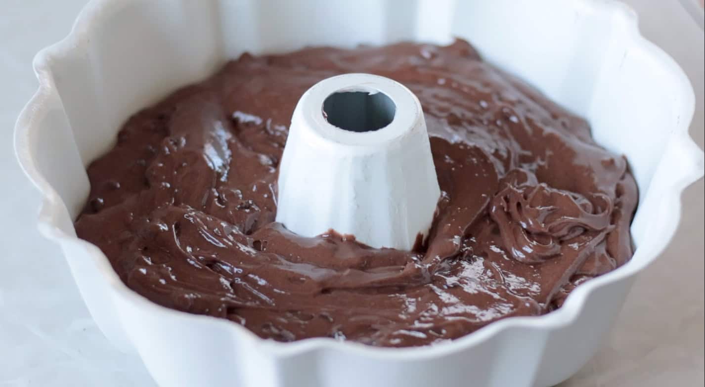 Bundt cake pan with cake batter poured into it.