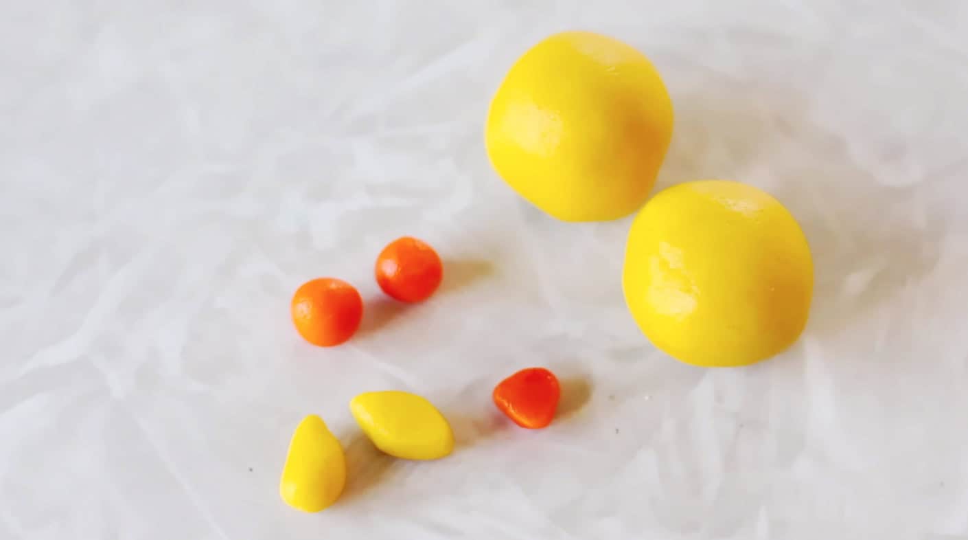 Cookie dough rolled into yellow and orange balls.