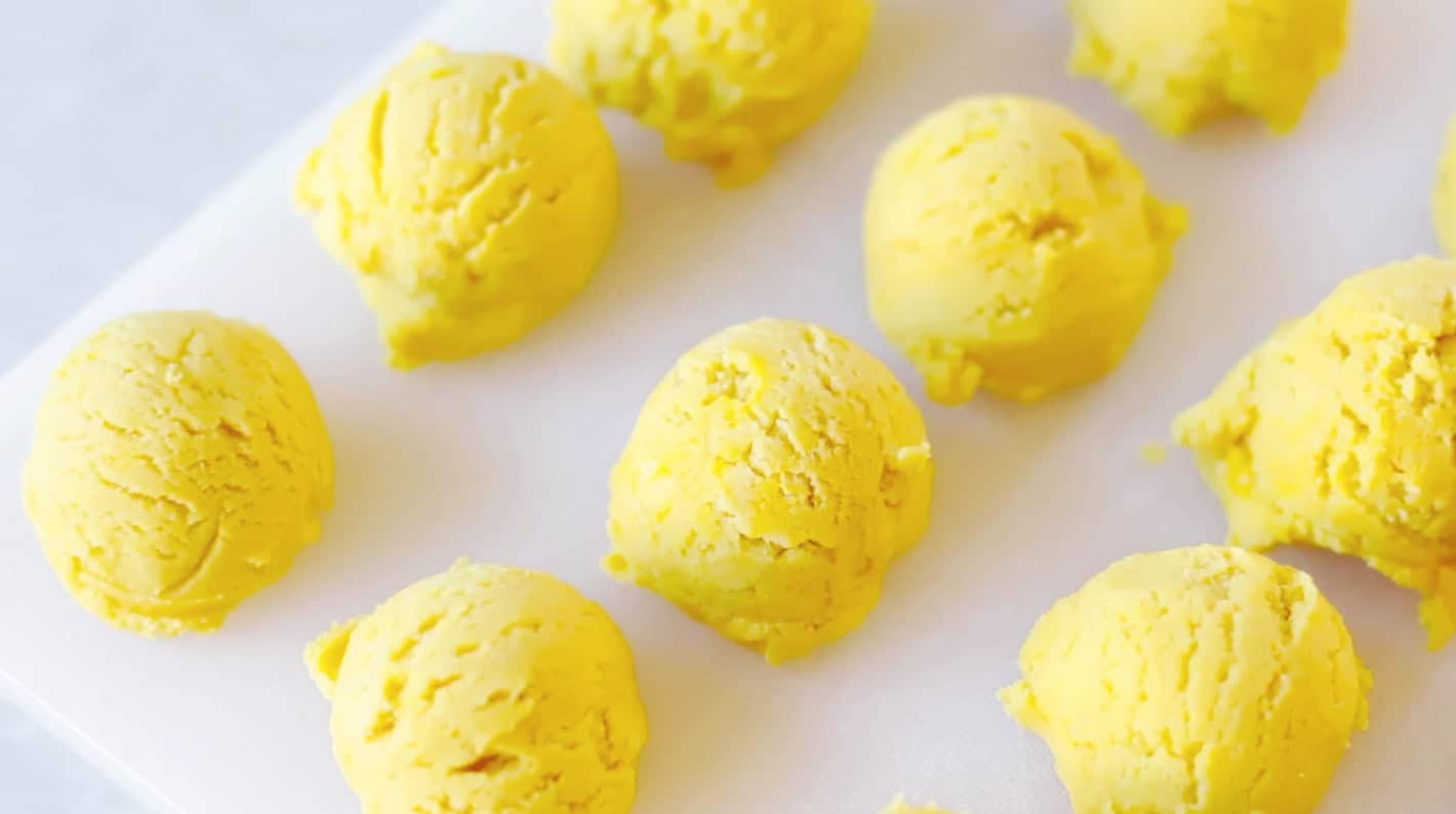 Yellow balls of sugar cookie dough.