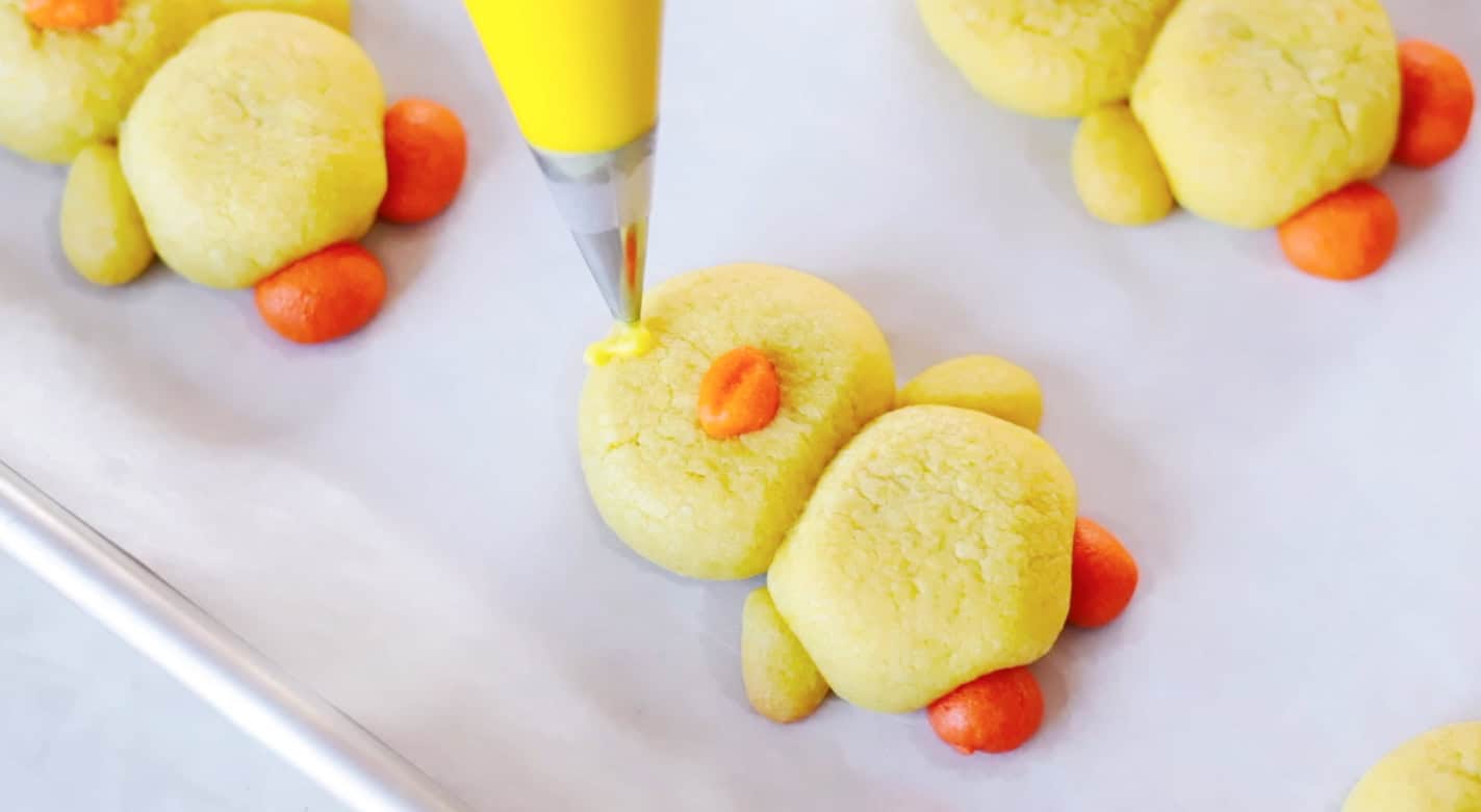 Yellow frosting added to chick sugar cookie for feathers.