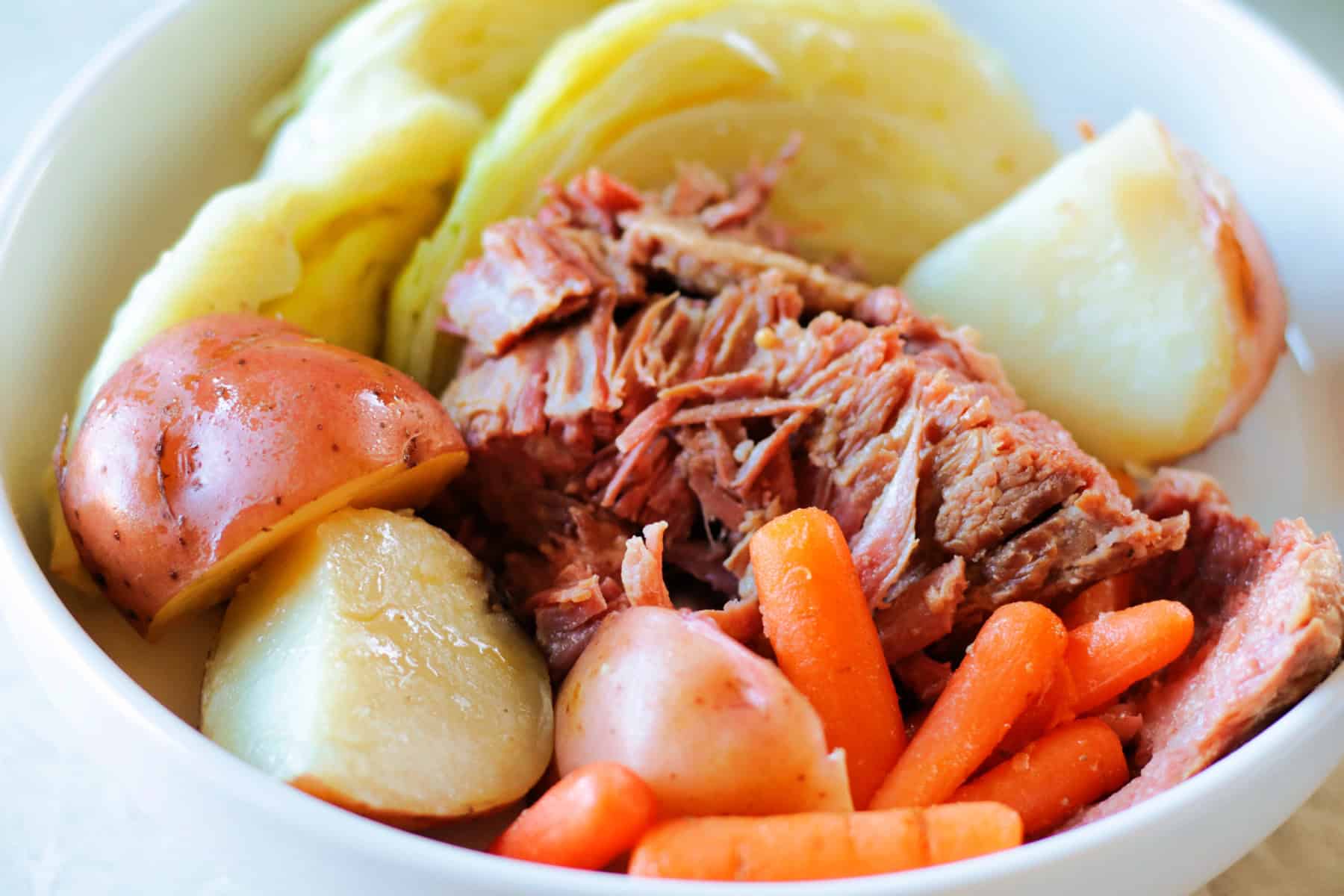 Bowl of corned beef, potatoes, cabbage and carrots.