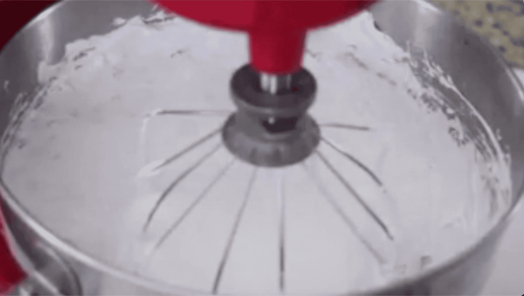 Stand mixer bowl with fluffed marshmallow mixture.