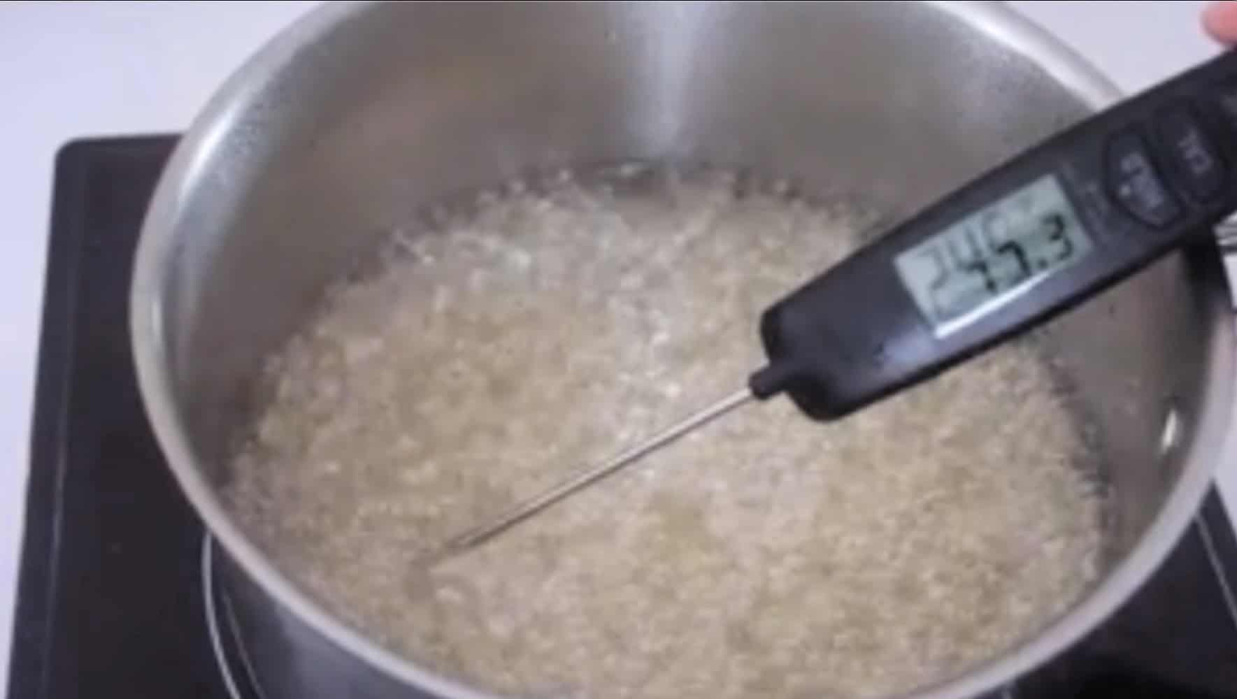 Saucepan with boiling marshmallow mixture and candy thermometer.