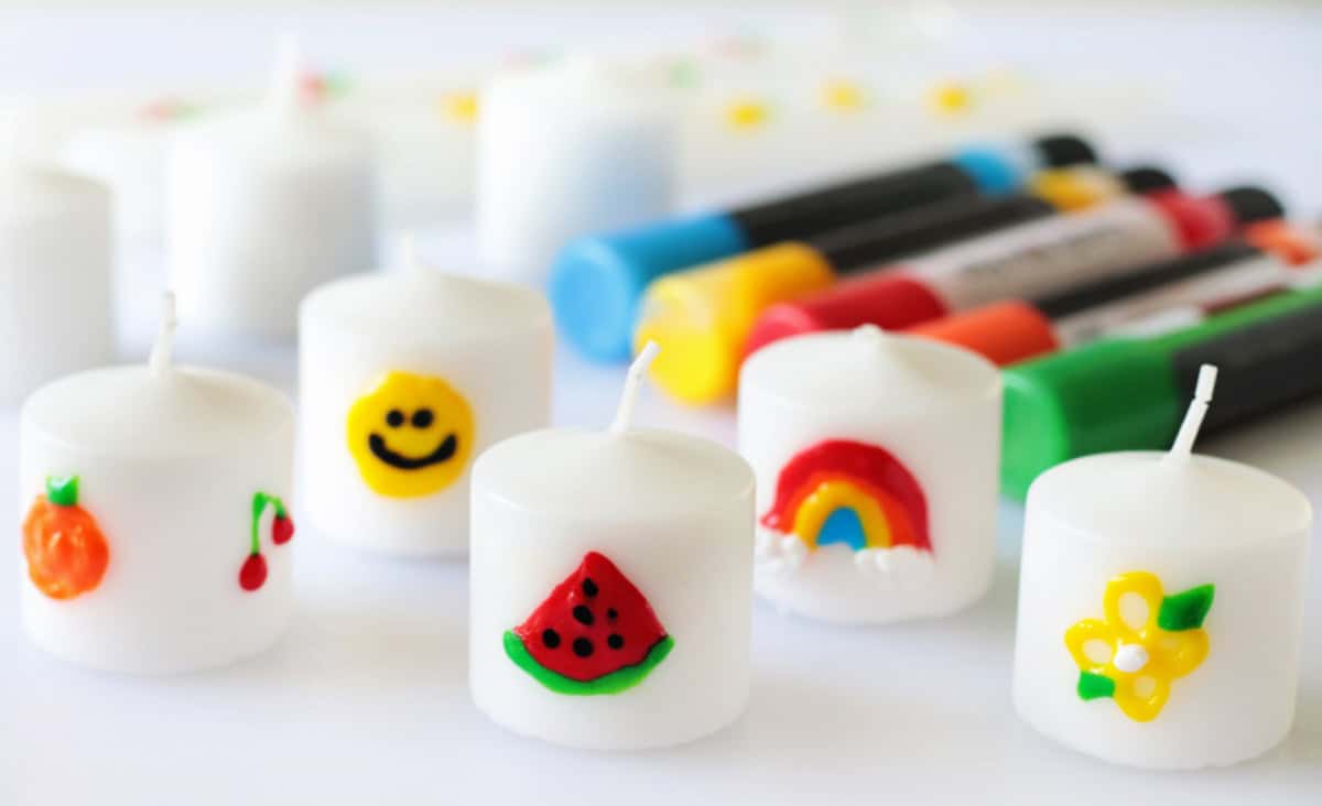 White votives decorated with color wax pens.