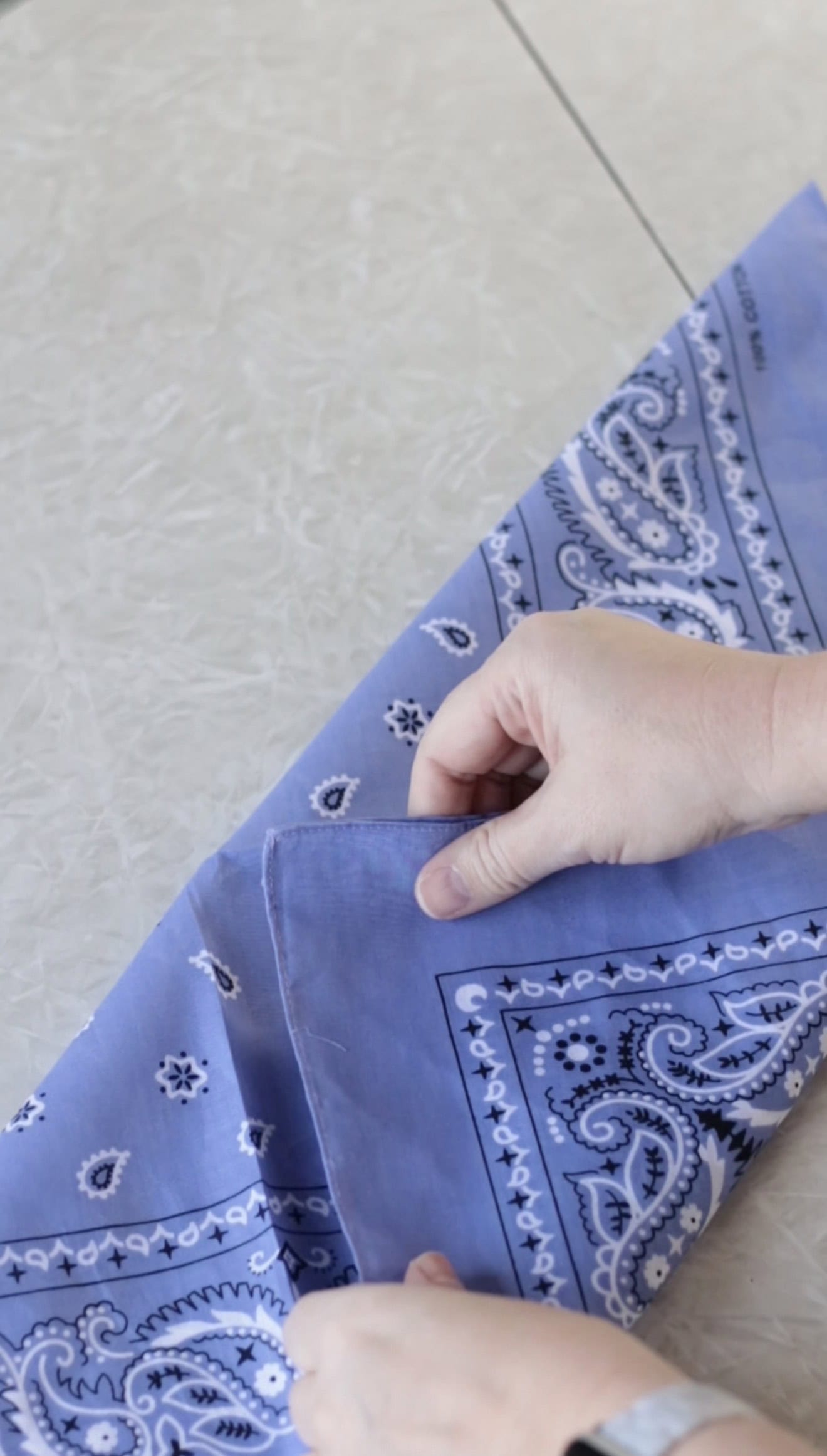 Bandana folded in half then folded once more.