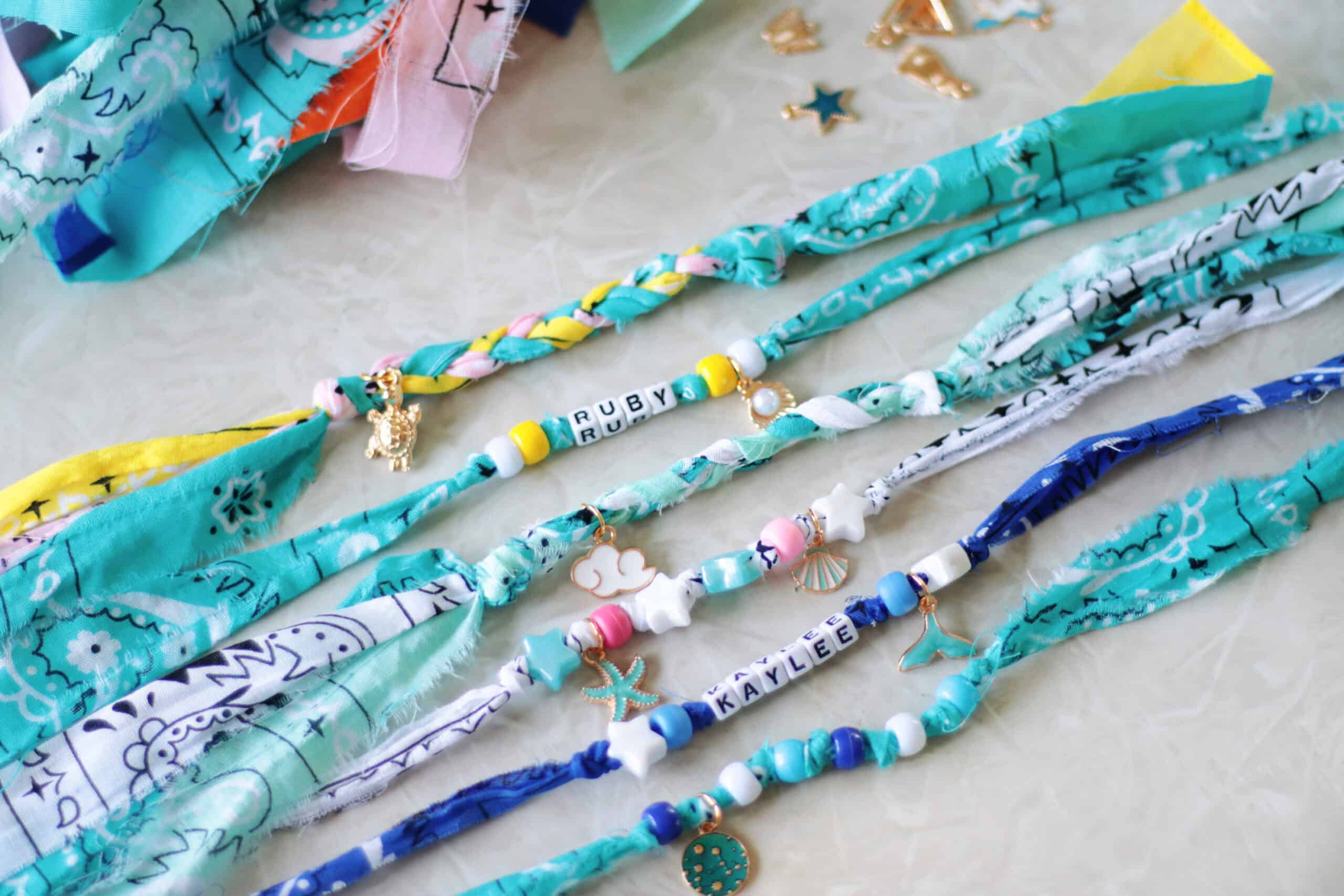 Bandana bead bracelets lined up on a table.