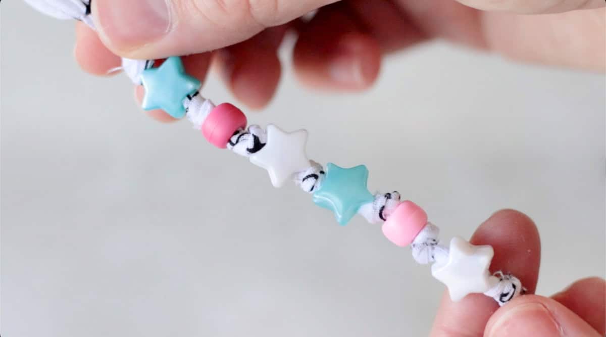 White bandana bracelet with star beads.