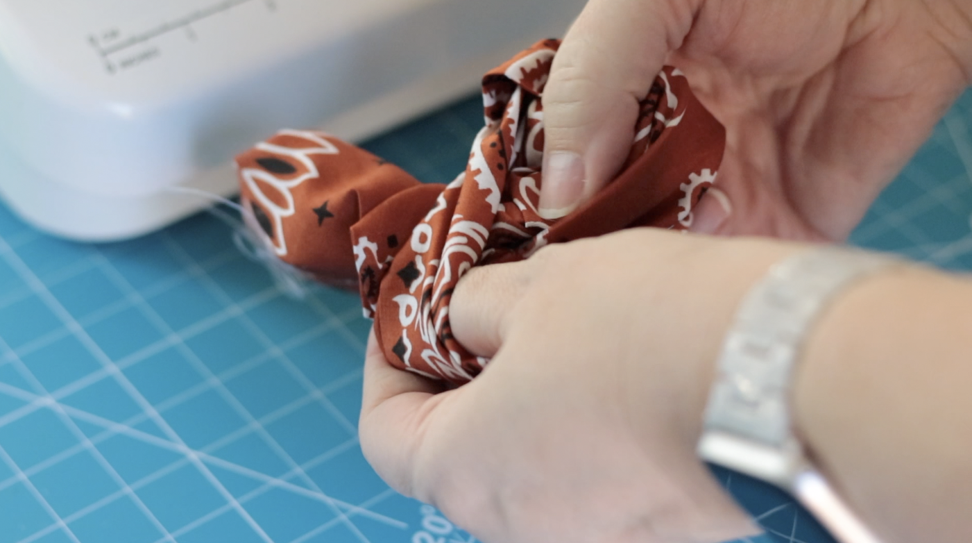 Hands turning the pocket right side out.