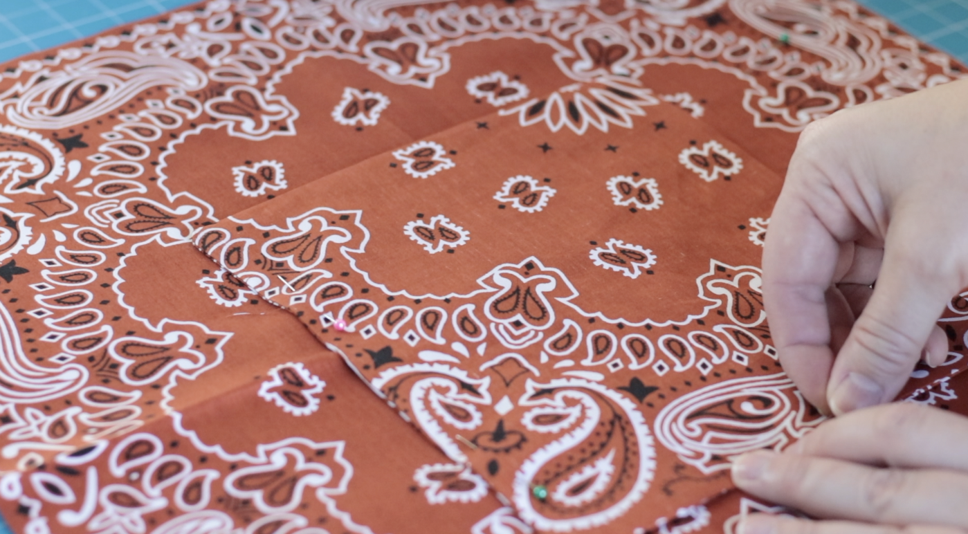 Hands pinning pocket to lining.