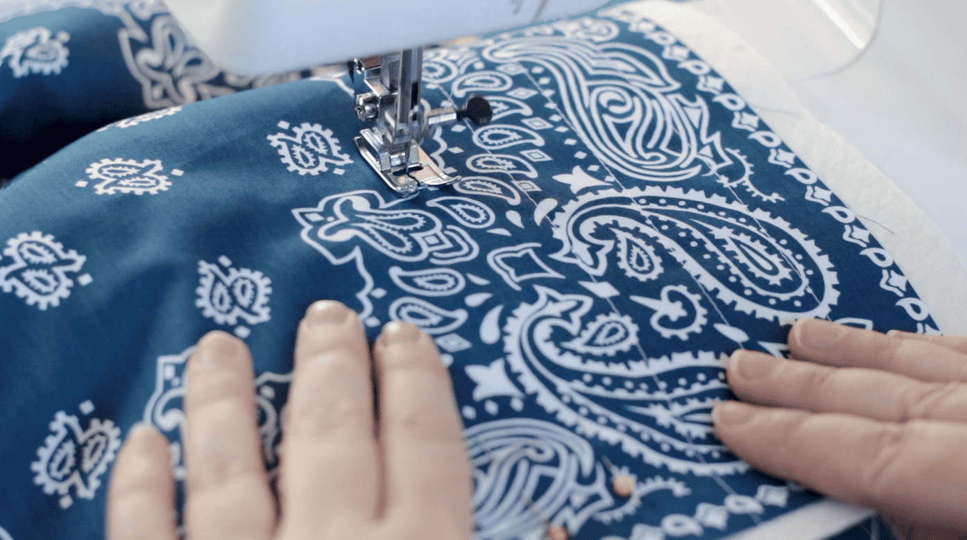 Sewing machine sewing quilt lines.