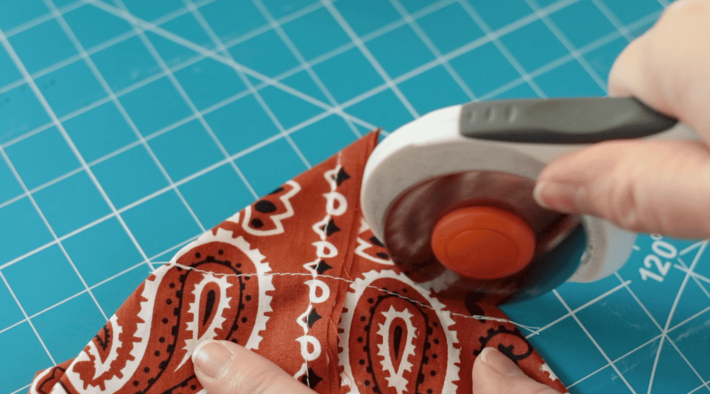 Rotary cutter cutting fabric.