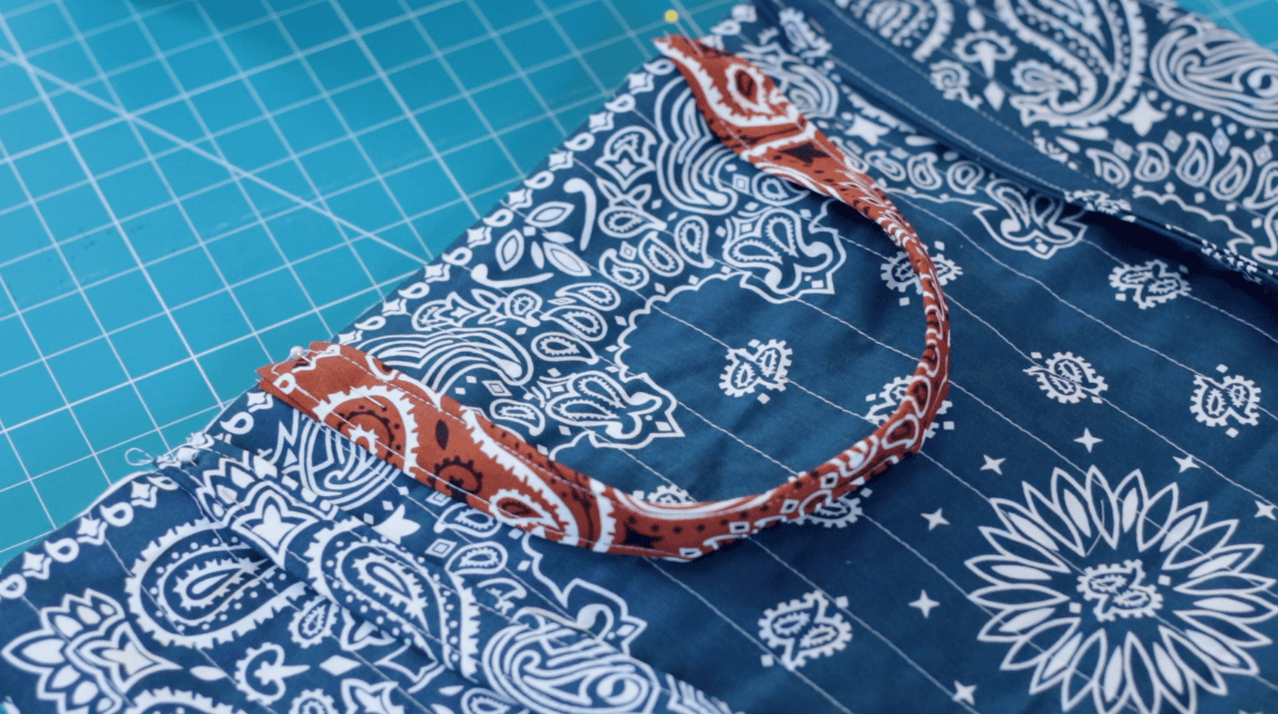 Fabric handles pinned to bag.