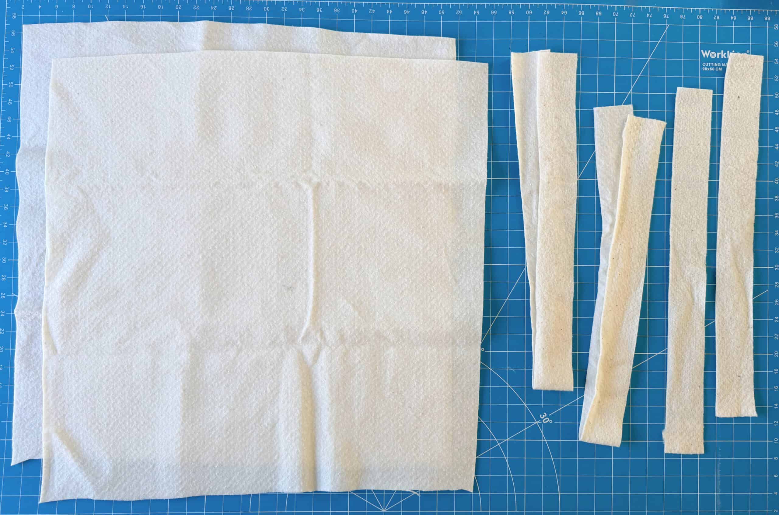 Batting cut into large squares and thin strips.