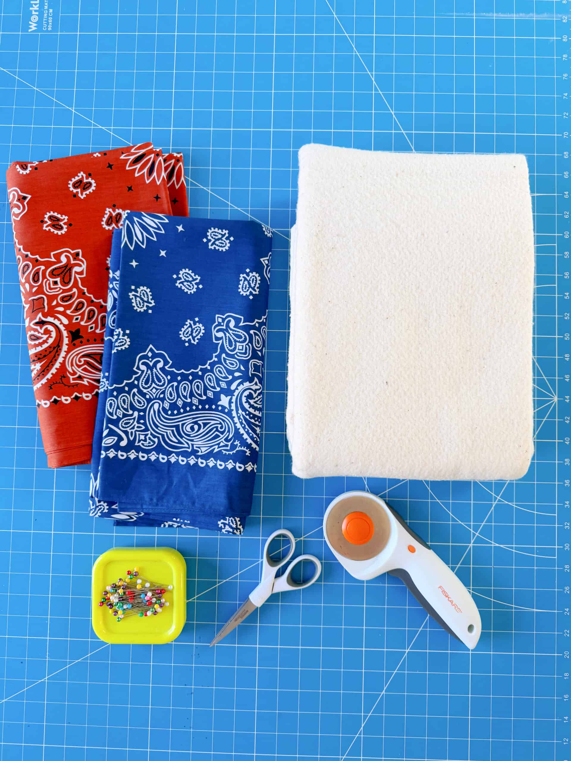 Bandanas, batting, rotary cutter, scissors and sewing pins.