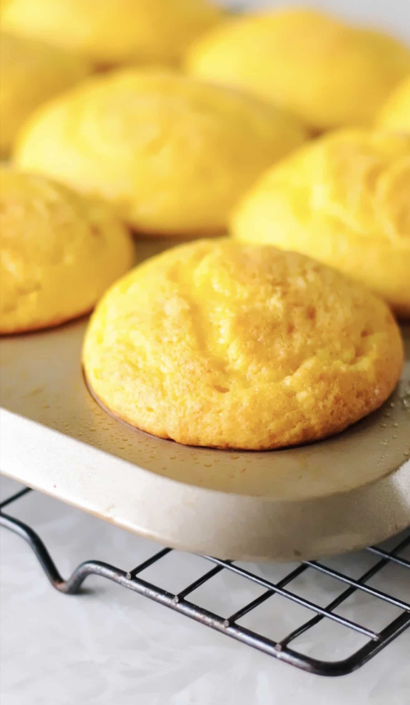 Baked yellow cupcakes in pan.
