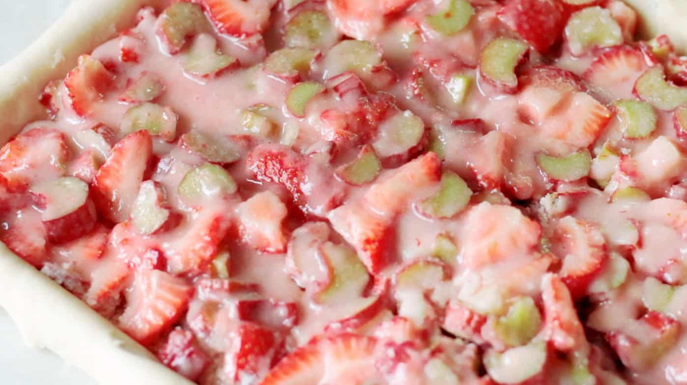 Strawberry rhubarb filling on top of pie crust.