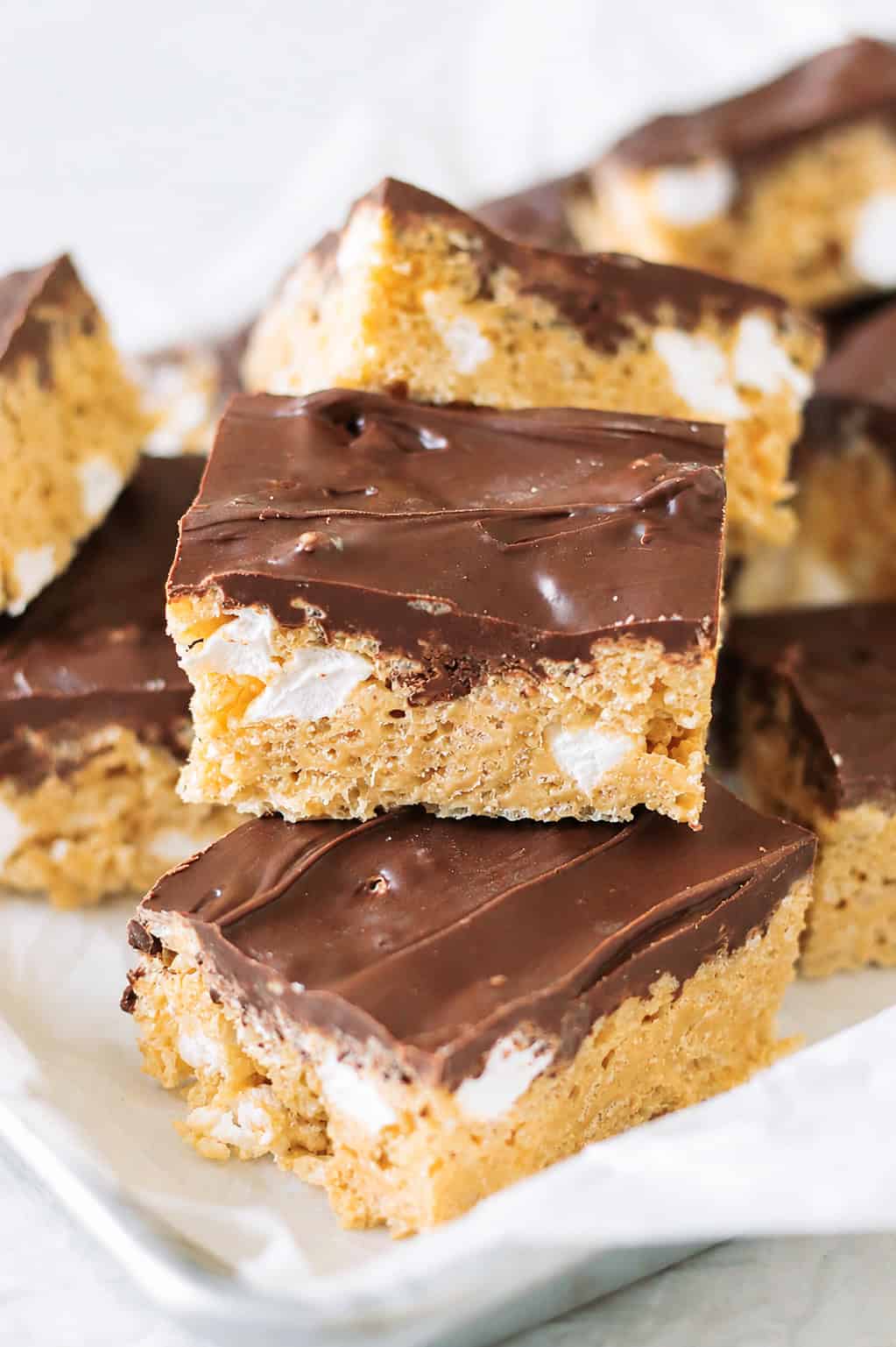 Marshmallow scotcheroos stacked on a tray.