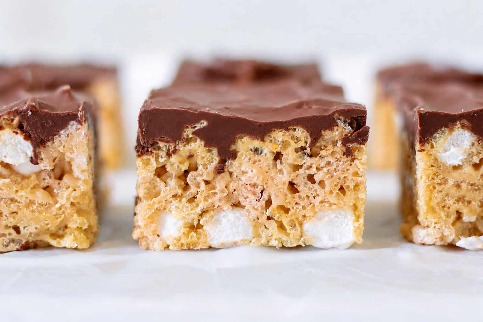 Marshmallow scotcheroos on parchment paper.