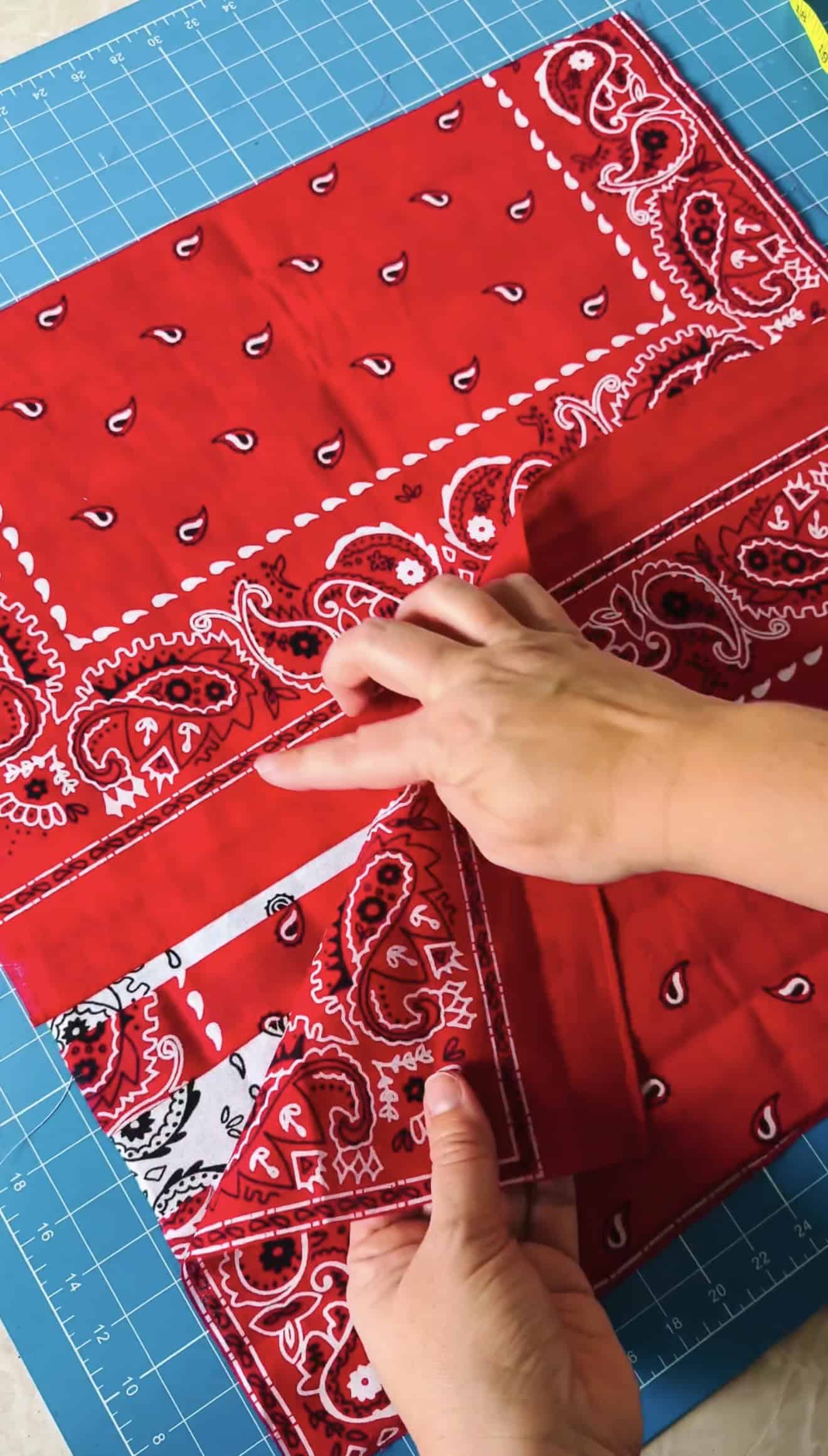 Hands placing two pieces of fabric on back of pillow cover.